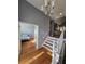 Bright entryway featuring hardwood floors, white railing staircase, and a view into the bedroom at 760 Whitehall Way, Roswell, GA 30076