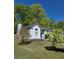 Home exterior featuring a side entry garage and a well-maintained lawn with mature trees at 760 Whitehall Way, Roswell, GA 30076