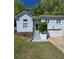 Charming home featuring well-maintained lawn, inviting entry, and convenient two-car garage at 760 Whitehall Way, Roswell, GA 30076