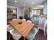 Open kitchen with stainless appliances, gray cabinetry, wood flooring, and wood accent wall at 760 Whitehall Way, Roswell, GA 30076