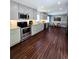Spacious kitchen with stainless steel appliances, ample cabinetry, and modern lighting at 760 Whitehall Way, Roswell, GA 30076