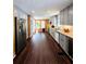 Extended kitchen showcasing wood accent wall, gray cabinetry, and stainless-steel appliances at 760 Whitehall Way, Roswell, GA 30076