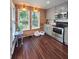 Bright kitchen with stainless appliances, gray cabinetry, wood flooring, and wood accent wall at 760 Whitehall Way, Roswell, GA 30076