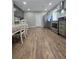 Eat-in kitchen has stainless steel appliances, gray cabinets, and wood-look floors at 760 Whitehall Way, Roswell, GA 30076