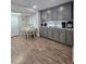 Eat-in kitchen has stainless steel appliances, gray cabinets, and wood-look floors at 760 Whitehall Way, Roswell, GA 30076
