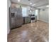 Eat-in kitchen has stainless steel appliances, gray cabinets, and wood-look floors at 760 Whitehall Way, Roswell, GA 30076