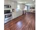 Bright kitchen with stainless appliances, gray cabinetry, and wood flooring at 760 Whitehall Way, Roswell, GA 30076