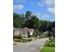 Charming street view of houses with lush landscaping, and mature trees at 760 Whitehall Way, Roswell, GA 30076