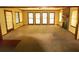 Large open living room featuring a brick fireplace and ample natural light from the many windows at 811 Verde Dr, Riverdale, GA 30274