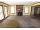 Living room with a brick fireplace, large windows, and a view of the home's open layout at 811 Verde Dr, Riverdale, GA 30274