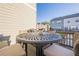 Relaxing back deck with a round table set, perfect for outdoor dining and enjoying neighborhood views at 3877 Via Cima Ln, Suwanee, GA 30024