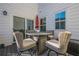 A cozy back patio features an outdoor dining set with comfortable seating, ideal for enjoying the outdoors at 3877 Via Cima Ln, Suwanee, GA 30024