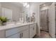 Bright bathroom featuring dual sinks, white cabinets, and a separate shower/toilet area at 3877 Via Cima Ln, Suwanee, GA 30024