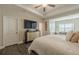 A bedroom with an entertainment center and view into the living room at 3877 Via Cima Ln, Suwanee, GA 30024