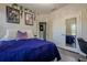 Comfortable bedroom with a mirrored closet, decorative wall art, and ample natural light at 3877 Via Cima Ln, Suwanee, GA 30024