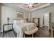 A luxury bedroom featuring hardwood floors, accent furniture, and recessed lighting at 3877 Via Cima Ln, Suwanee, GA 30024