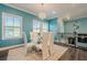Dining area with a modern chandelier, glass table, and white chairs, showcasing a stylish open-concept design at 3877 Via Cima Ln, Suwanee, GA 30024