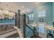 Bright foyer features wood stairs, a black iron railing, and a door with sidelights, plus a glimpse of the kitchen at 3877 Via Cima Ln, Suwanee, GA 30024