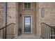 Inviting brick entryway with black front door and elegant house number at 3877 Via Cima Ln, Suwanee, GA 30024