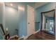Hallway with staircase, hardwood floors and large framed mirror on the wall at 3877 Via Cima Ln, Suwanee, GA 30024