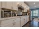 Well-equipped kitchen with white cabinets, subway tile backsplash, stainless appliances, and dark wood floors at 3877 Via Cima Ln, Suwanee, GA 30024