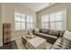 A living room with a large window and leather sectional sofa at 3877 Via Cima Ln, Suwanee, GA 30024