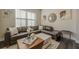 A cozy living room with a leather sectional and decorative wall art at 3877 Via Cima Ln, Suwanee, GA 30024