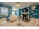 Bright living room featuring a fireplace, TV, lots of natural light, and hardwood floors at 3877 Via Cima Ln, Suwanee, GA 30024