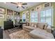 Cozy home office space with comfortable seating and lots of natural light at 3877 Via Cima Ln, Suwanee, GA 30024