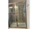 A tiled stand up shower with sliding glass door and adjustable shower head at 3877 Via Cima Ln, Suwanee, GA 30024