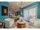 Sitting room with lots of light, hardwood floors and modern light fixture at 3877 Via Cima Ln, Suwanee, GA 30024