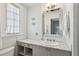 Charming bathroom boasts marble countertops, under sink cabinet and drawer storage, and a decorative mirror at 391 Collier Nw Rd, Atlanta, GA 30309