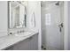 This bathroom features marble countertops, a glass door shower, a decorative mirror, and great lighting at 391 Collier Nw Rd, Atlanta, GA 30309