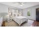 Bright bedroom featuring hardwood floors, a ceiling fan, a window, and tasteful decor and furniture at 391 Collier Nw Rd, Atlanta, GA 30309