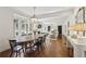 Dining room adjacent to living room area with hardwood floors and many windows at 391 Collier Nw Rd, Atlanta, GA 30309