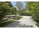 Gravel driveway surrounded by mature trees and landscaping provides a private and welcoming entrance at 391 Collier Nw Rd, Atlanta, GA 30309