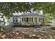 Exterior view of white home with black shutters, inviting entrance, and beautiful landscaping at 391 Collier Nw Rd, Atlanta, GA 30309