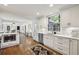 Well-lit kitchen with white cabinetry, stainless steel appliances, and a clear sightline into the home's living spaces at 391 Collier Nw Rd, Atlanta, GA 30309
