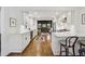 Open kitchen with white cabinetry, hardwood floors, breakfast bar, and a seamless flow into the living room at 391 Collier Nw Rd, Atlanta, GA 30309
