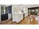 Bright kitchen features white cabinets, stainless steel appliances, and a view into the living area at 391 Collier Nw Rd, Atlanta, GA 30309
