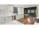 Beautiful kitchen with white cabinets, stainless appliances, and a view to the living room with built-in bookshelves at 391 Collier Nw Rd, Atlanta, GA 30309