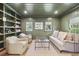Cozy living room with olive green walls, built-in shelving, and comfortable seating bathed in natural light at 391 Collier Nw Rd, Atlanta, GA 30309