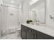 Bright bathroom featuring a white subway tile shower-tub, gray vanity with solid surface countertop and marble floors at 605 Stone Field Nw Run, Marietta, GA 30060