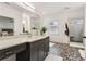 This bathroom features a pebble floor, walk-in shower, and grey cabinets with a white countertop at 605 Stone Field Nw Run, Marietta, GA 30060