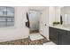 This bathroom has a walk-in shower and grey cabinets with a white countertop and a pebble floor at 605 Stone Field Nw Run, Marietta, GA 30060