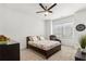 Comfortable bedroom with a ceiling fan, a chair near the window, and neutral tones at 605 Stone Field Nw Run, Marietta, GA 30060