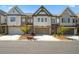 Charming townhomes featuring brick and siding exteriors, complemented by well-maintained landscaping at 605 Stone Field Nw Run, Marietta, GA 30060