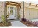 Charming entryway with a decorative wreath, stylish planters, and inviting curb appeal at 605 Stone Field Nw Run, Marietta, GA 30060