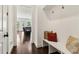 Hallway with a bench, coat hooks, and a view to the living area with hardwood flooring at 605 Stone Field Nw Run, Marietta, GA 30060