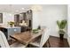 Kitchen open to dining area, features gray cabinets, stainless appliances, kitchen island and modern lighting at 605 Stone Field Nw Run, Marietta, GA 30060